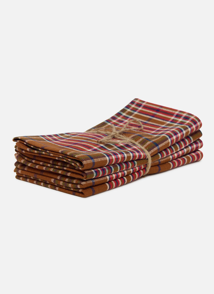 Stack of four Charlotte plaid holiday napkins in handwoven nutmeg and red cotton