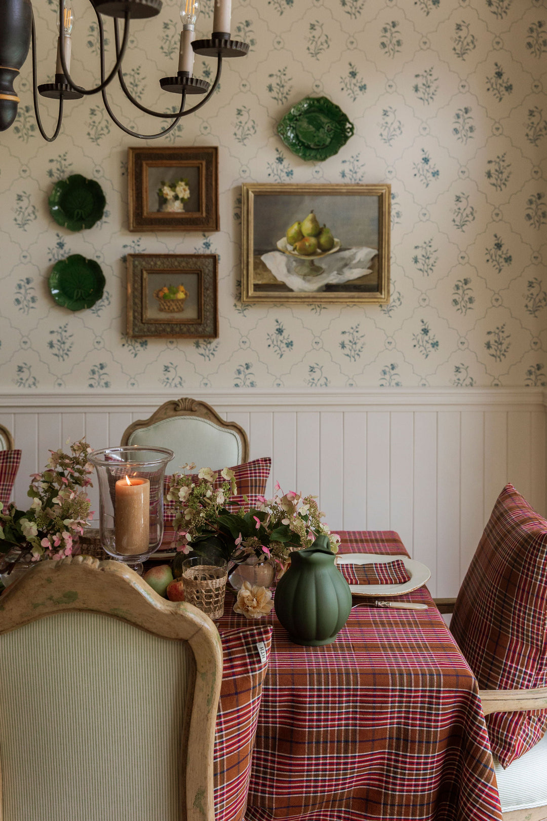 Charlotte plaid tablecloth on a dining table in a papered room set for a holiday meal