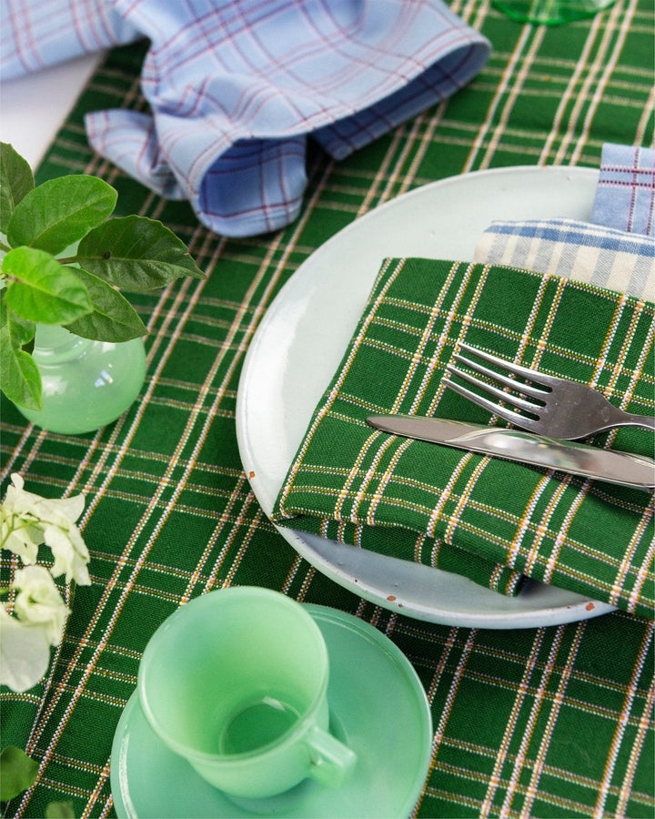Forest green plaid table runner styled on a festive holiday table