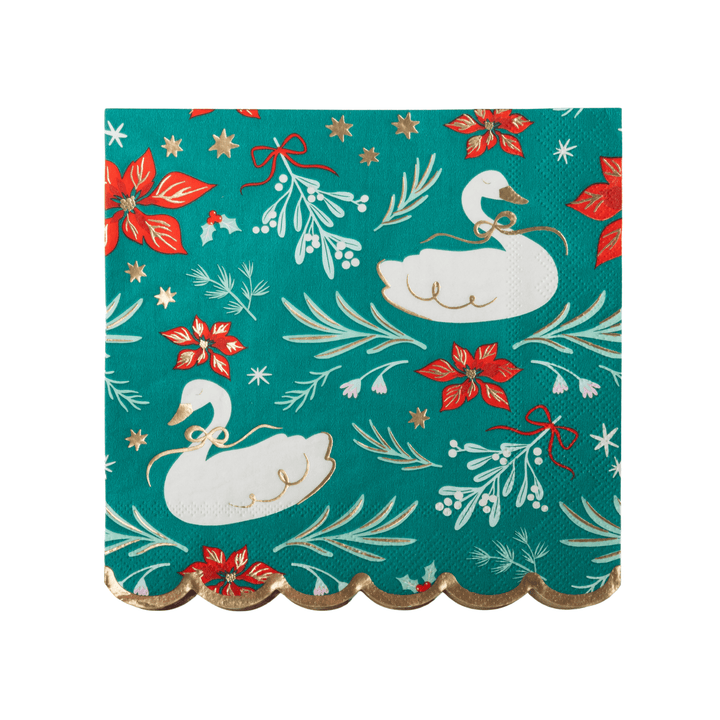 A square paper napkin with a scalloped gold edge, featuring a festive holiday pattern of white swans, red poinsettias, mistletoe, and gold stars on a teal background, isolated on a white studio background.