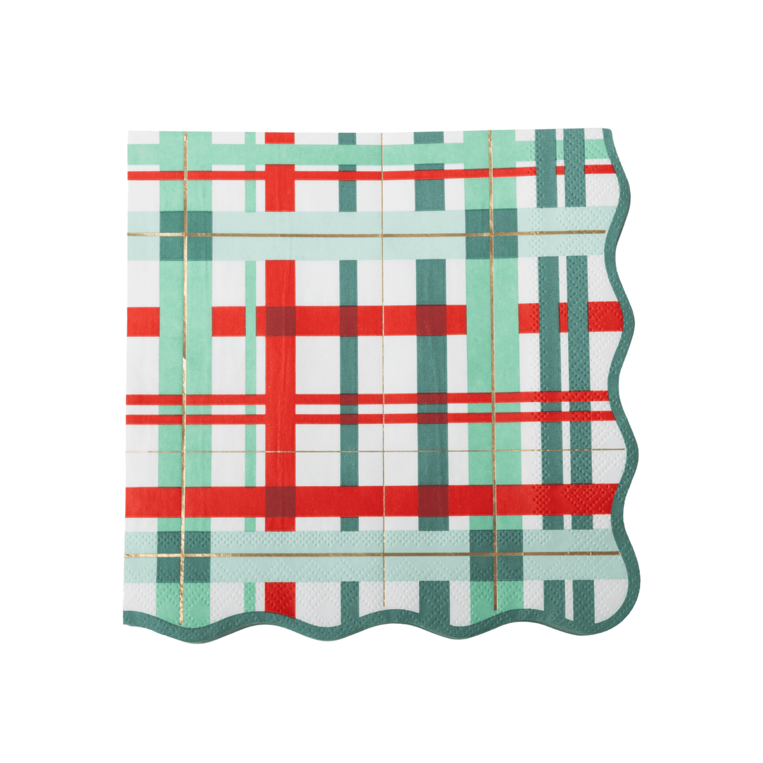 A square paper napkin with a festive plaid pattern in red, mint green, and dark teal on a white background, featuring a scalloped wavy edge.