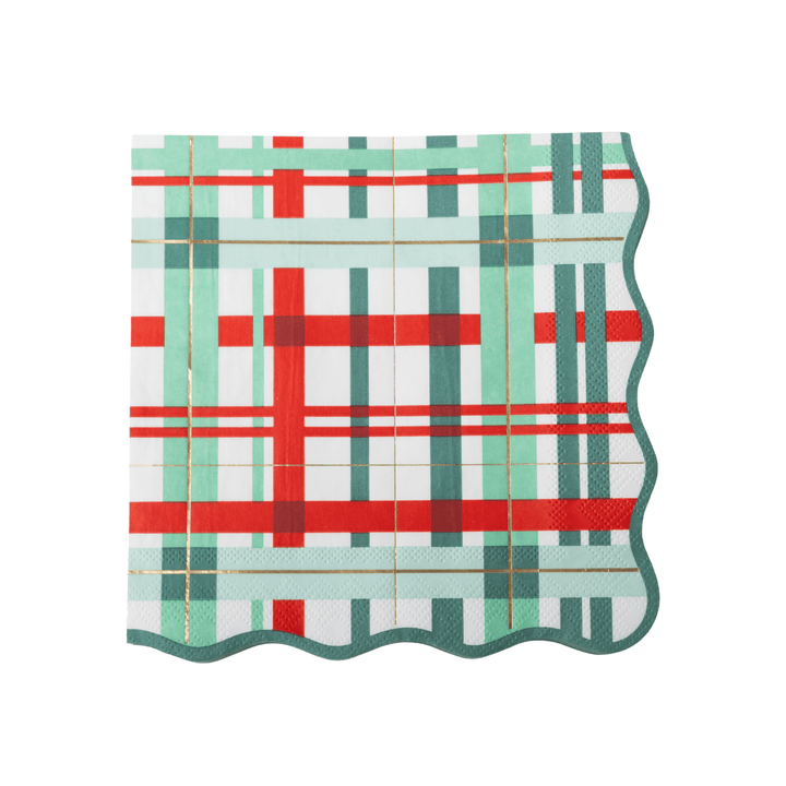 A square paper napkin with a festive plaid pattern in red, mint green, and dark teal on a white background, featuring a scalloped wavy edge.