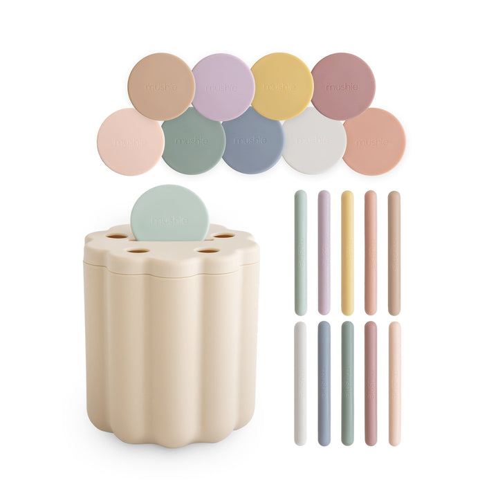 Mushie coin and tube sorting set with a scalloped storage box and 20 colorful pieces