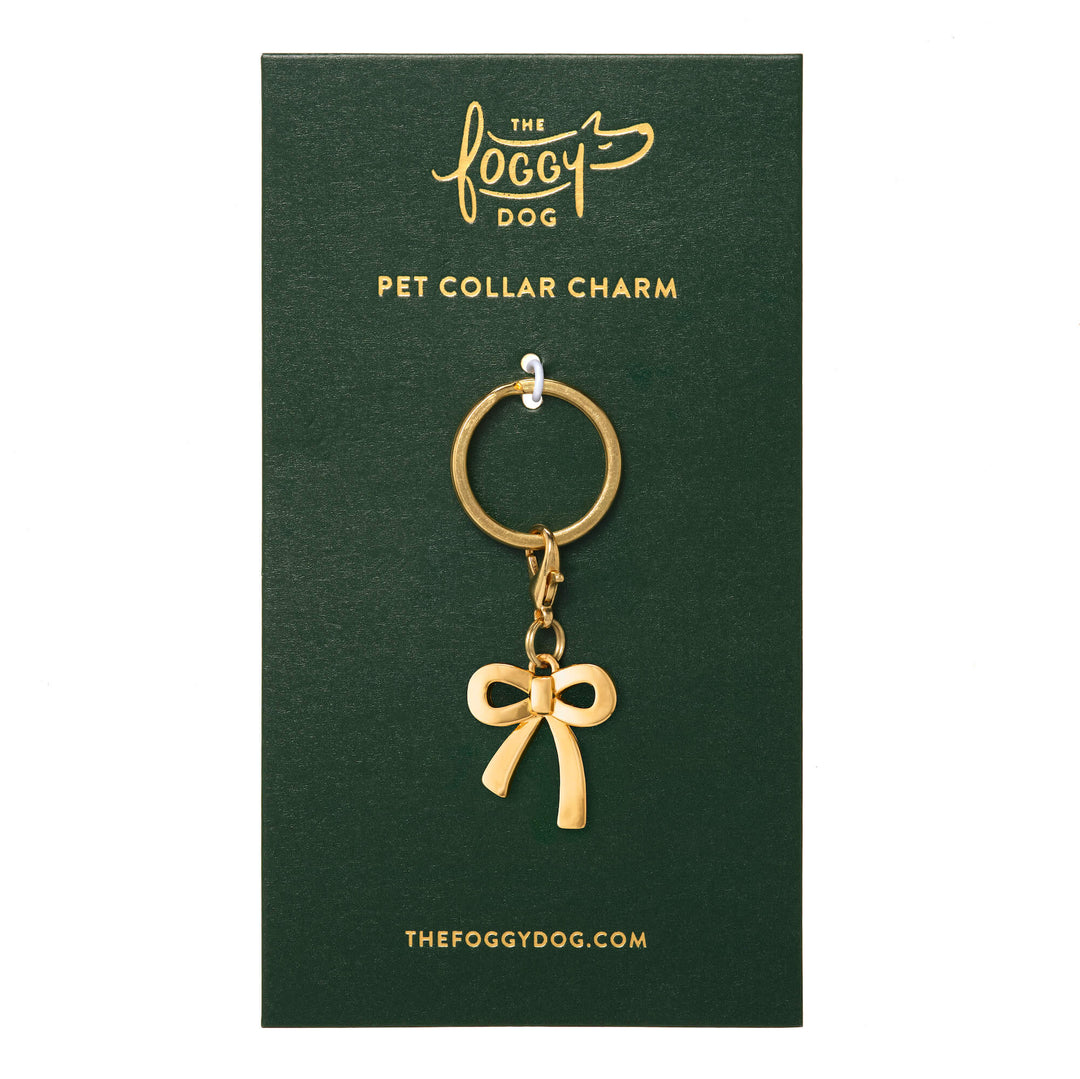 Gold bow collar charm on its green The Foggy Dog backer card