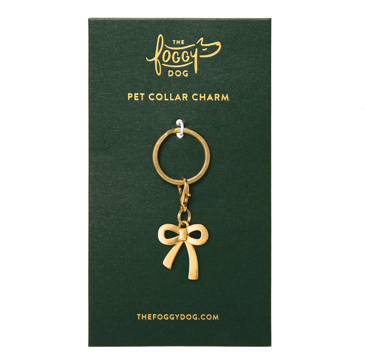 Gold bow collar charm on its green The Foggy Dog backer card