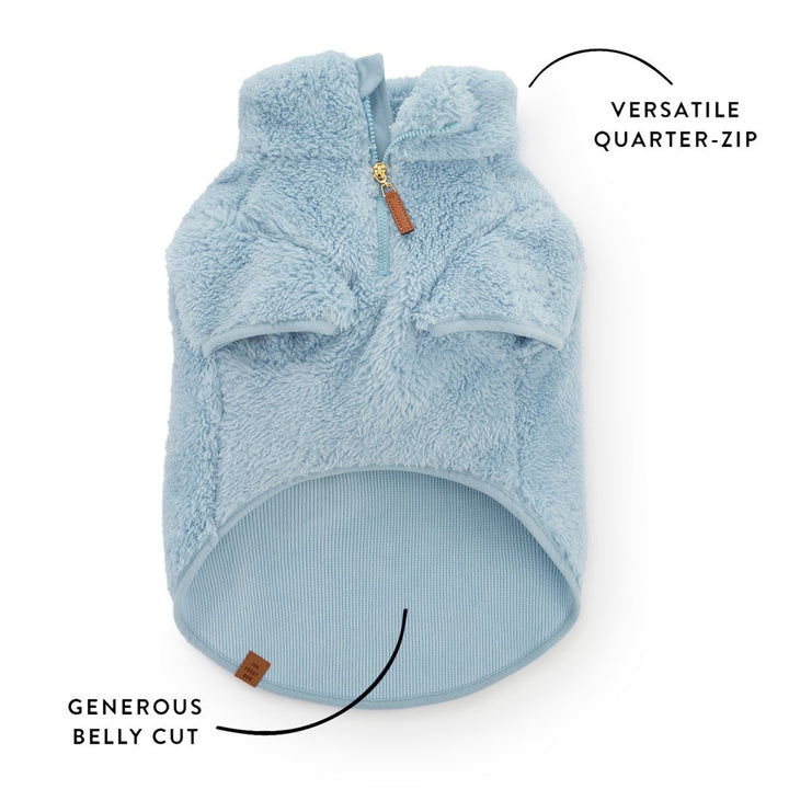 Callout of the sherpa jacket front showing the quarter-zip and ribbed belly cut