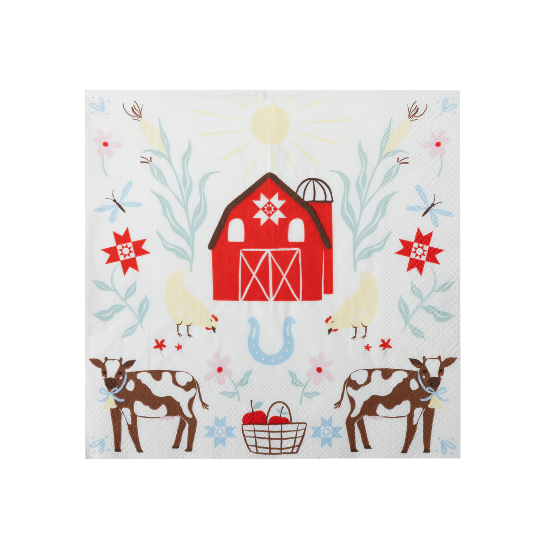 A square white paper napkin featuring a colorful country farm illustration with a red barn, cows, chickens, flowers, and a blue horseshoe.