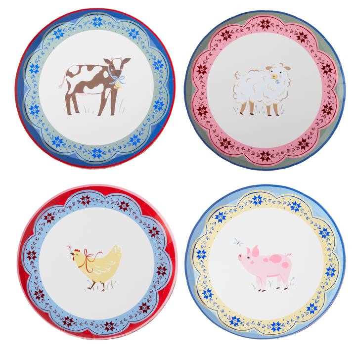 Four decorative round plates arranged in a 2x2 grid on a white background. Each plate has a scalloped floral border and a central animal illustration: a brown-and-white cow on a blue plate, a white sheep on a pink plate, a yellow hen on a red plate, and a pink pig on a light blue plate.