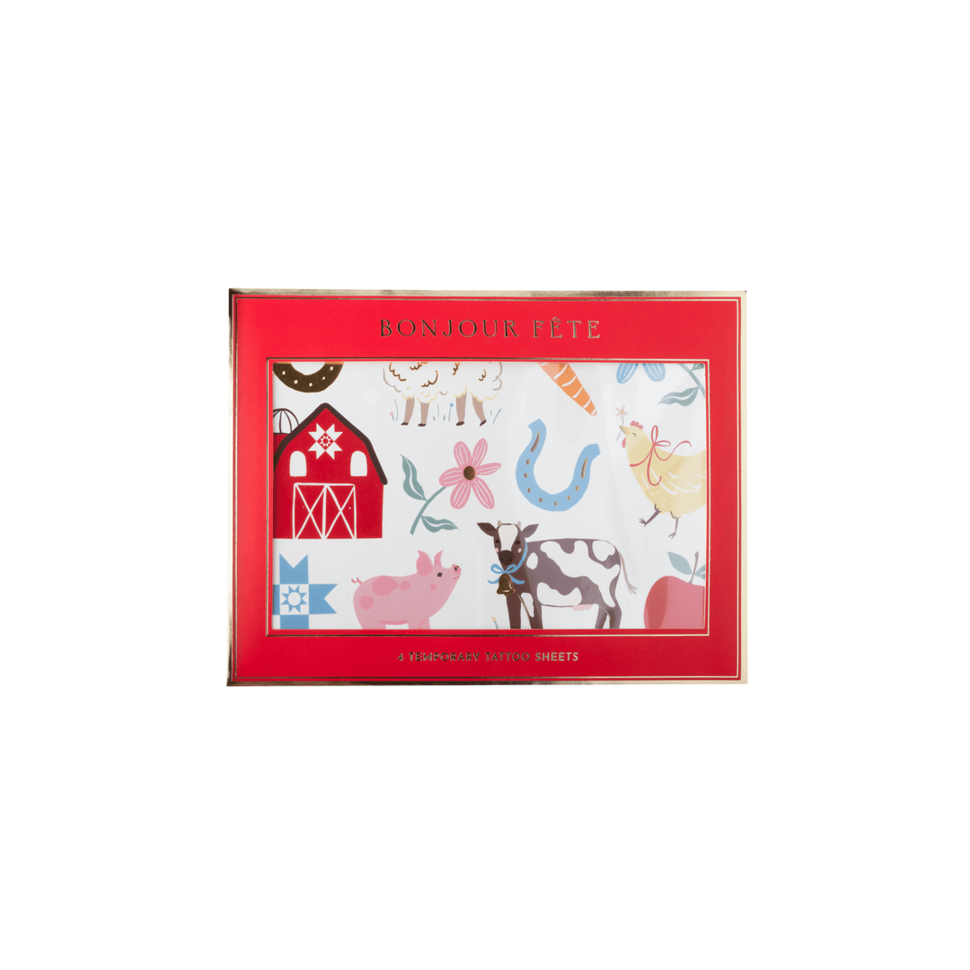 A set of temporary tattoos with a red border and a white center printed with colorful farm-themed illustrations including a barn, pig, cow, chicken, and flowers. The top of the box reads 'Bonjour Lête'.