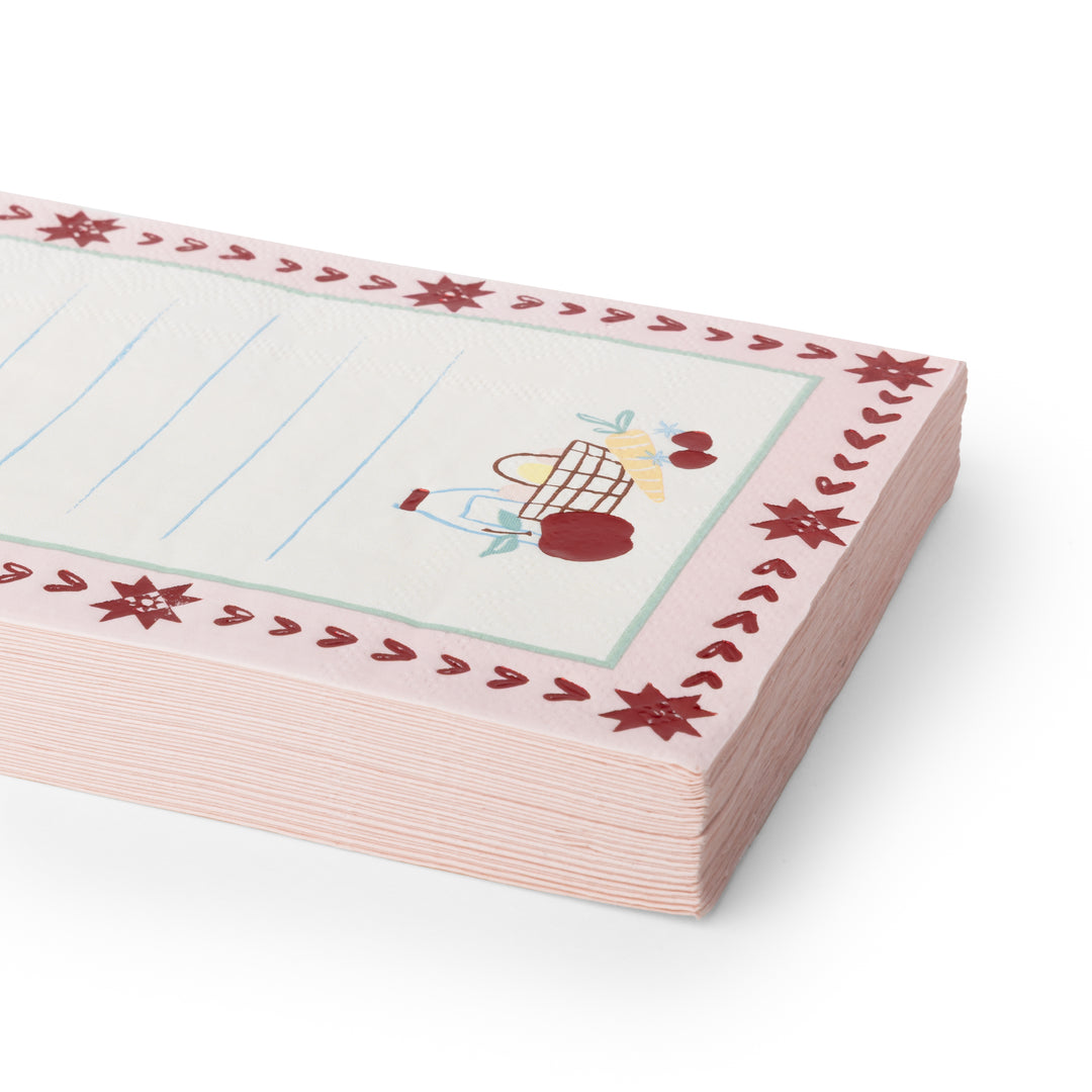 A stack of pink lined notepads napkins with a decorative border featuring red stars and a small cartoon character, shown on a clean white background.