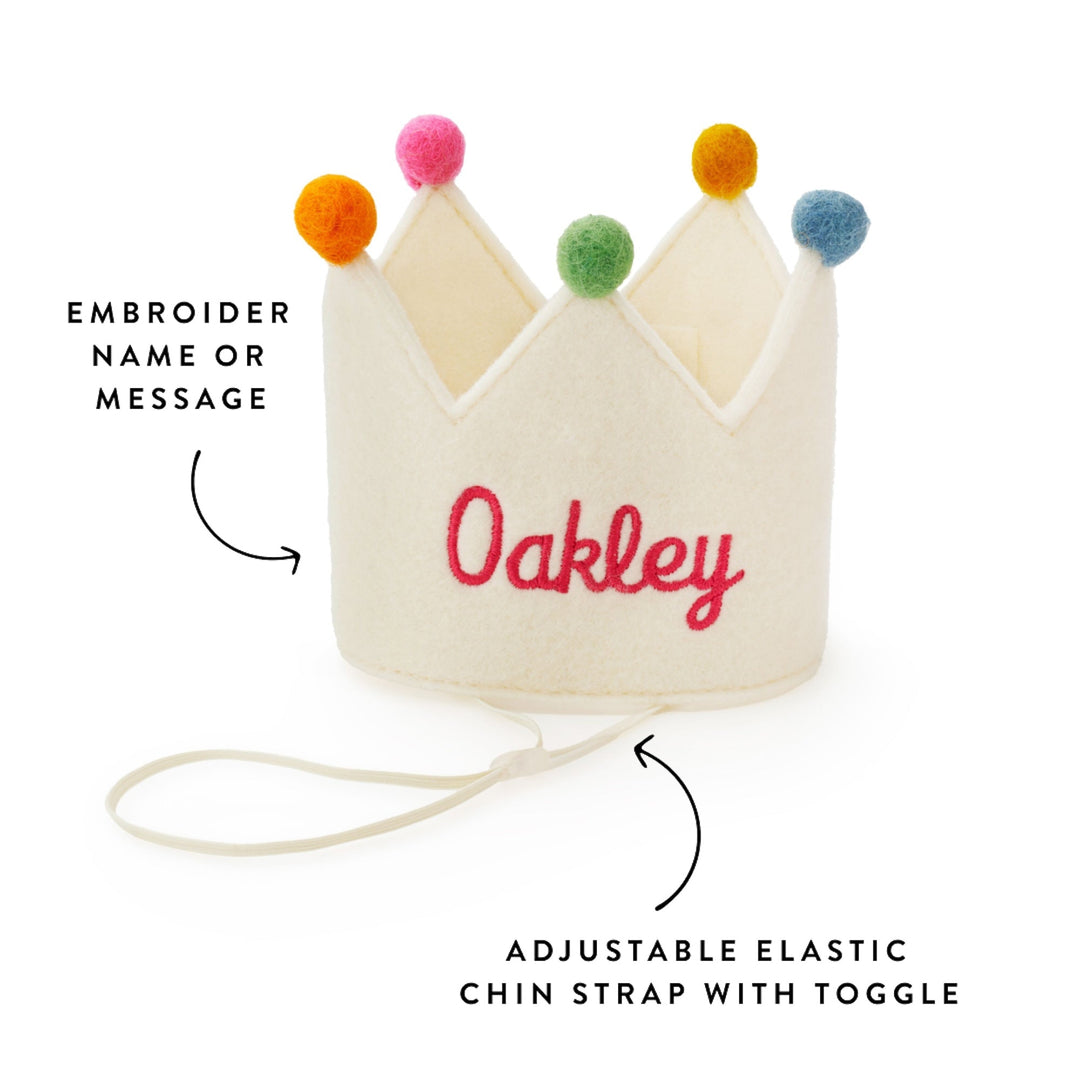 Ivory crown embroidered Oakley with callouts for the name embroidery and the elastic chin strap