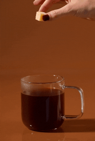 Coffee mixer cube dissolving into a fresh cup of coffee