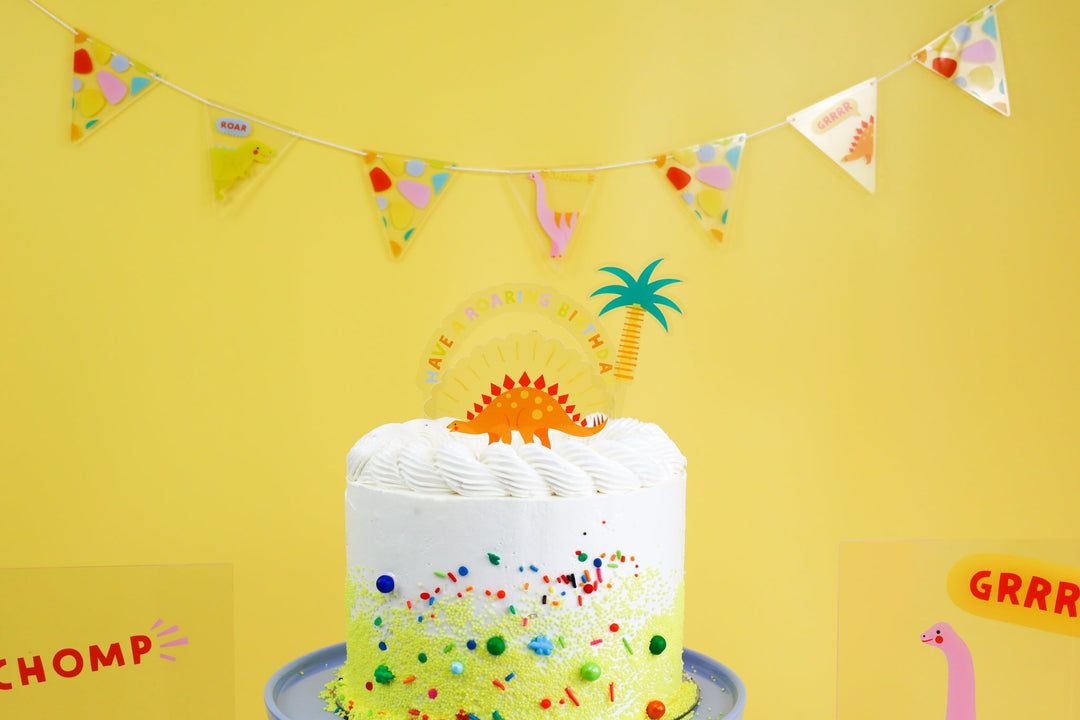Acrylic dinosaur cake toppers in the Dino-mite design from Joyeux Company