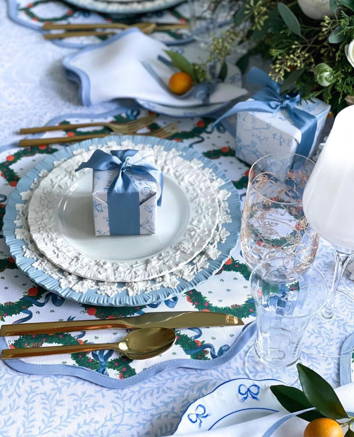 Round scalloped placemat in the Holiday Wreath print, Cornflower Blue, from Frances Fields Home