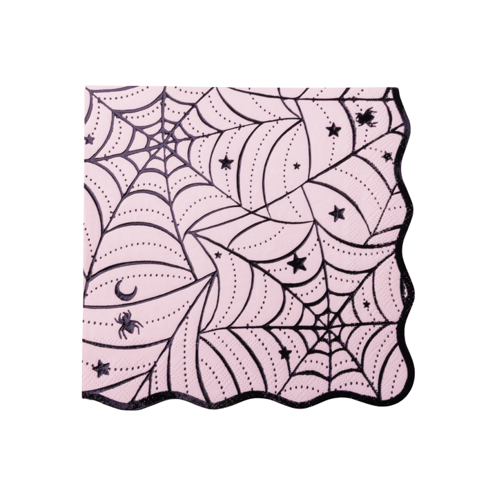 Pink paper napkins with a black spiderweb and moon pattern, shown on a clean white background.