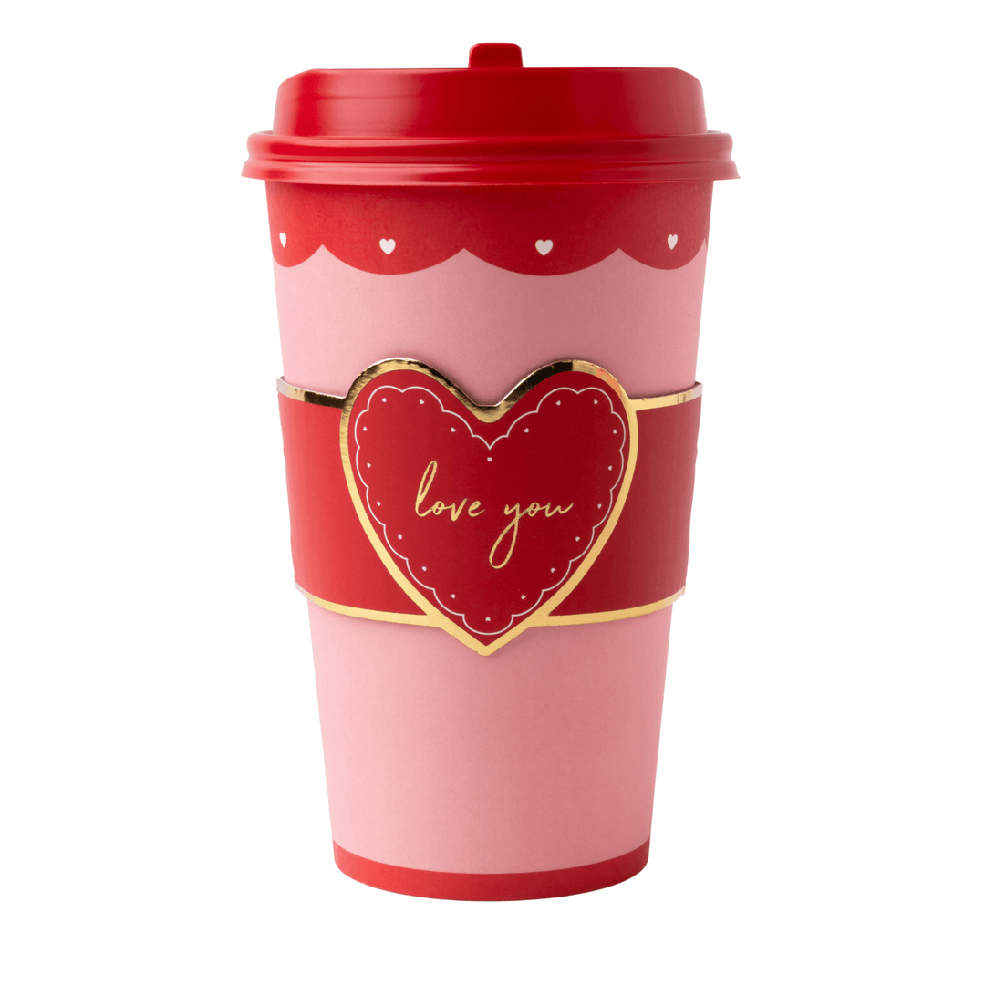 A pink and red reusable coffee cup with a red lid, a red heart-shaped sleeve featuring gold trim and the words 'love you' in gold script, and small white heart details near the top.