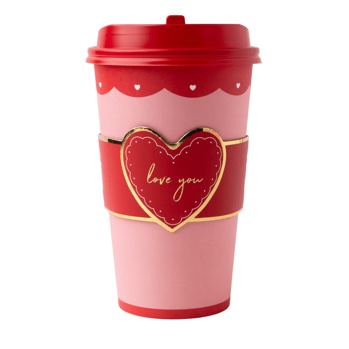 A pink and red reusable coffee cup with a red lid, a red heart-shaped sleeve featuring gold trim and the words 'love you' in gold script, and small white heart details near the top.
