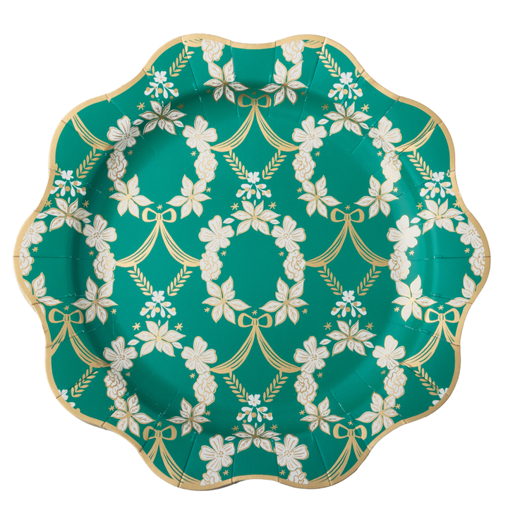 A scalloped paper plate featuring a teal green background with a repeating white floral wreath pattern and a metallic gold border.