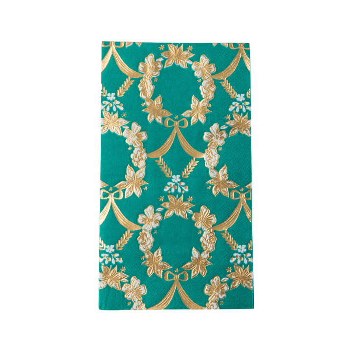 A stack of emerald green paper napkins with a gold floral vine pattern, photographed on a clean white background.
