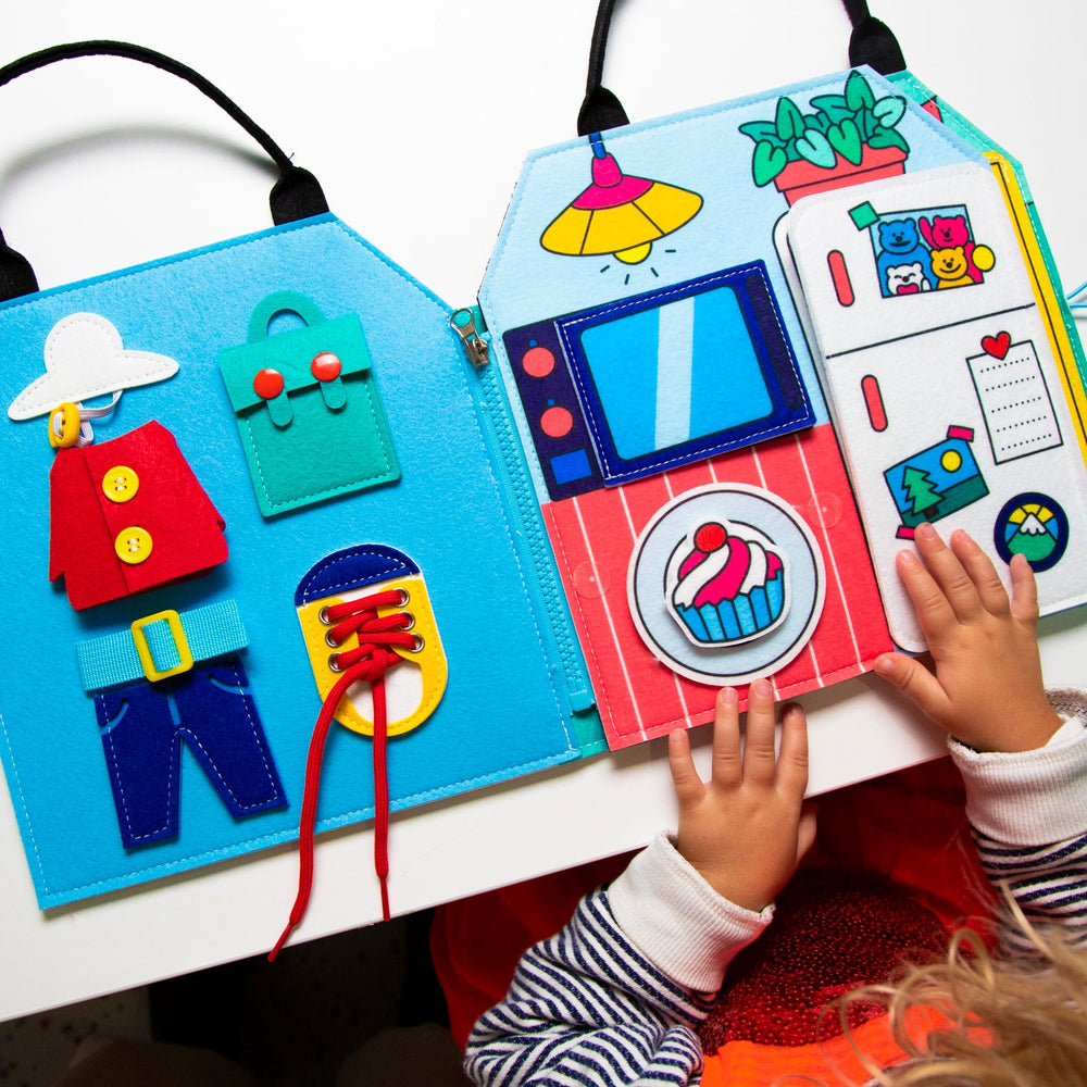 Child playing with the opened felt Montessori activity kit showing daily-routine activities