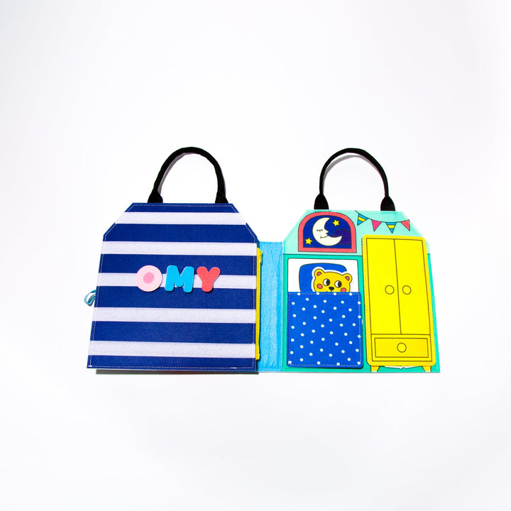 Folded felt Montessori activity kit in striped and dotted fabric with a carry handle