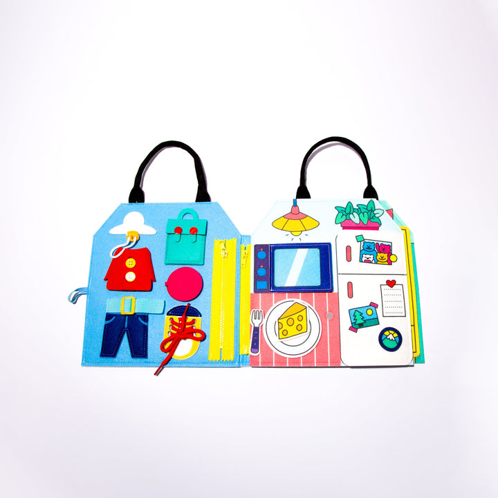 Felt Montessori activity kit opened upright, showing zip, button, and dressing activities