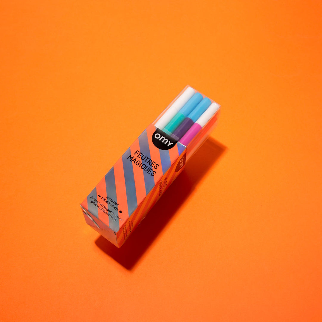 Boxed set of color-changing magic markers on an orange background