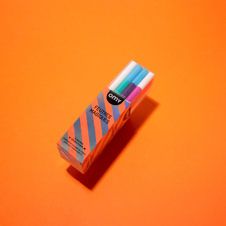 Boxed set of color-changing magic markers on an orange background