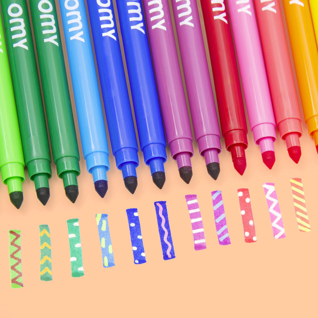 Fanned set of magic markers in rainbow colors with color swatches on an orange background