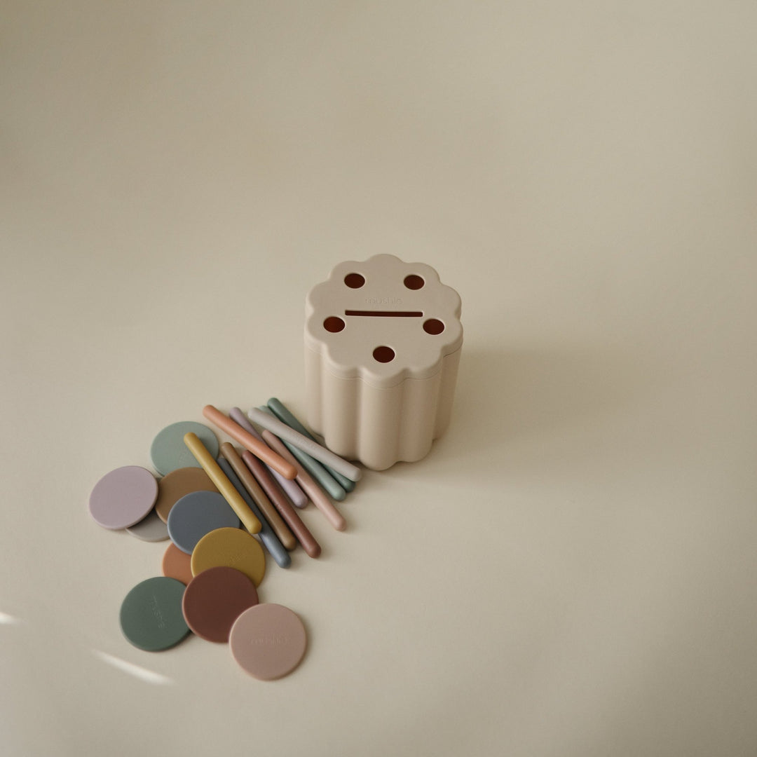 Flat lay of the Mushie coin and tube sorting set