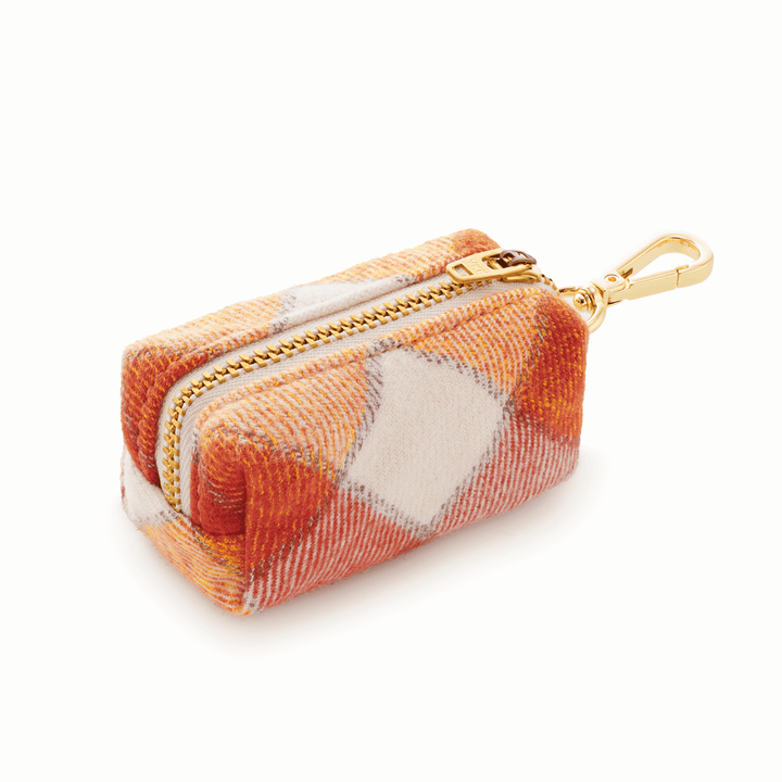 Side view of the plaid flannel poop bag holder showing its boxy shape and gold swivel clasp