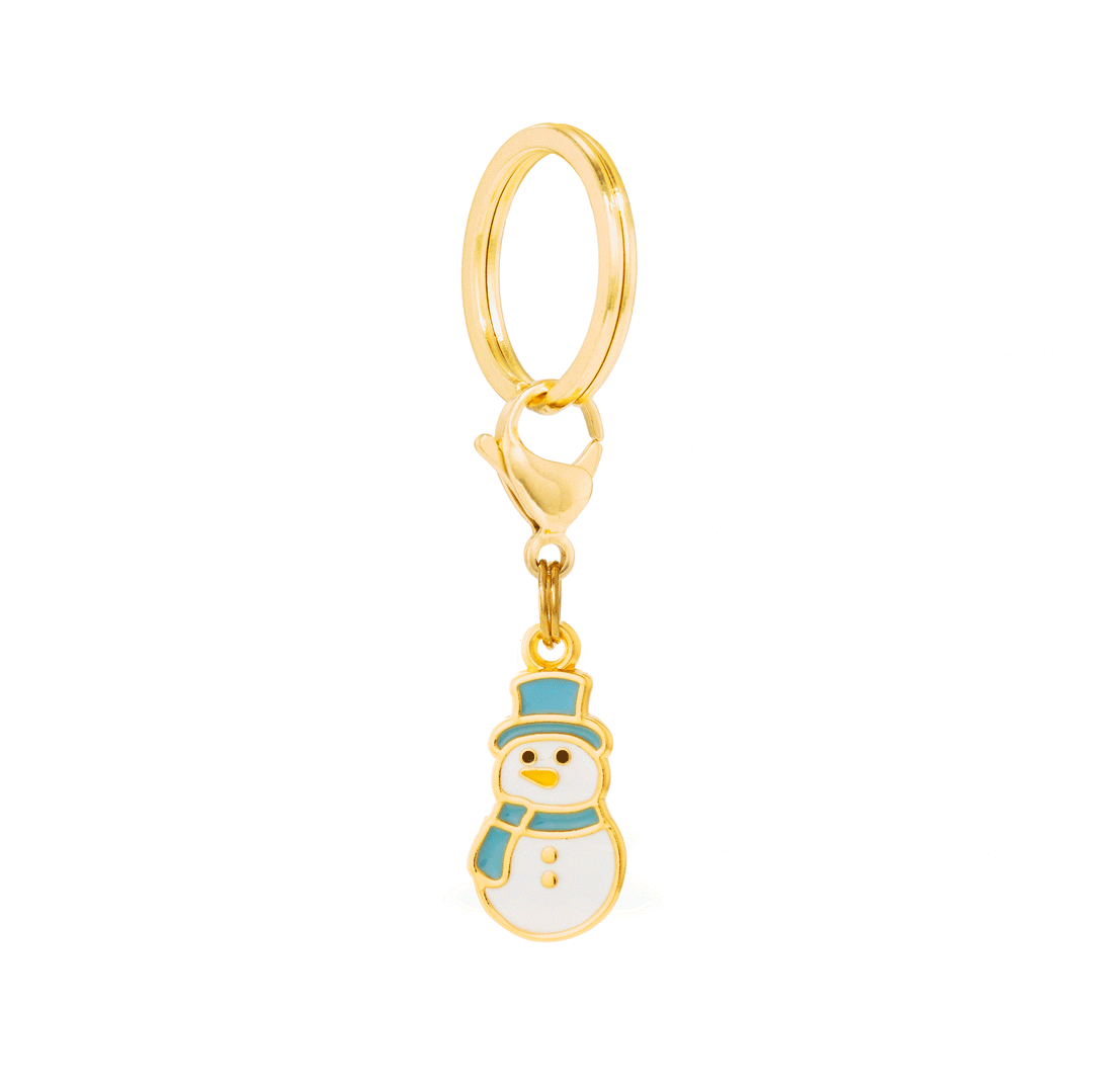 Snowman dog charm hanging from a gold split ring and clasp, seen at a slight angle