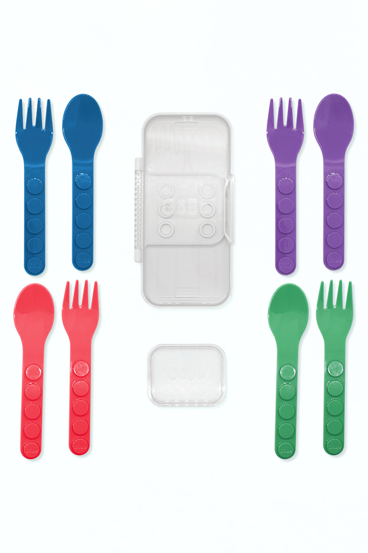 GoBe fork and spoon set laid out in blue, red, purple, and green with the travel case