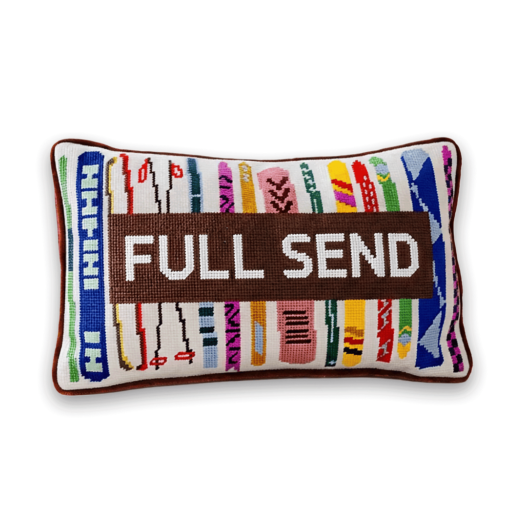 Full Send ski needlepoint lumbar pillow with colorful skis and a Miami border for a ski lodge or apres ski gift
