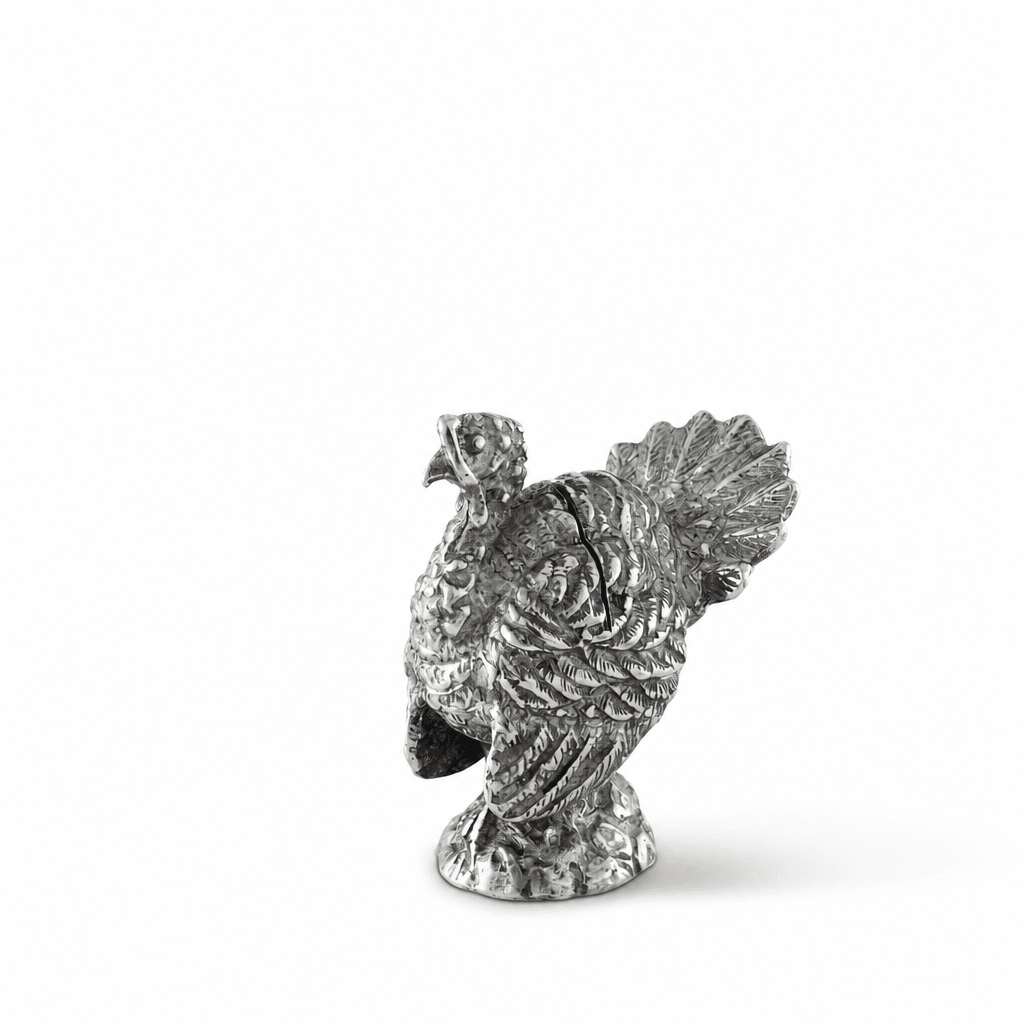 Side view of the pewter turkey place card holder showing its fanned tail and round base