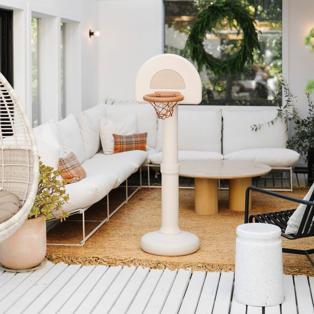 Ivory Gathre hoop styled in a sunroom with white sofas and a wreath on the wall