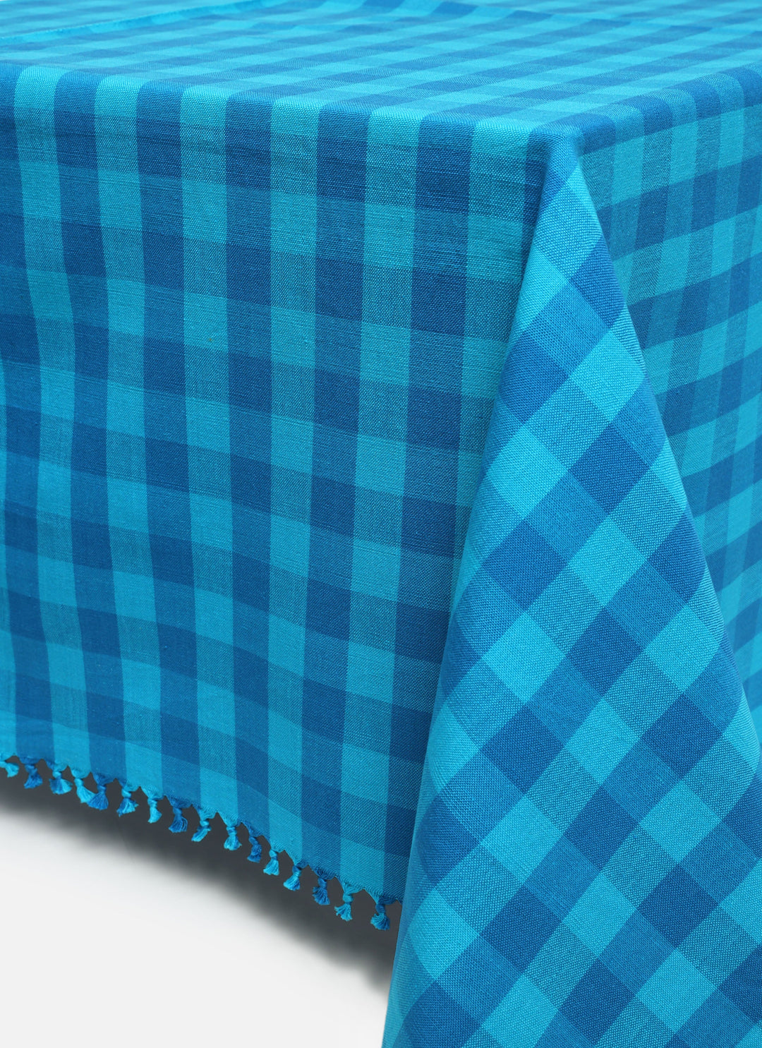 Turquoise gingham tablecloth in two tones of handwoven blue cotton shown flat