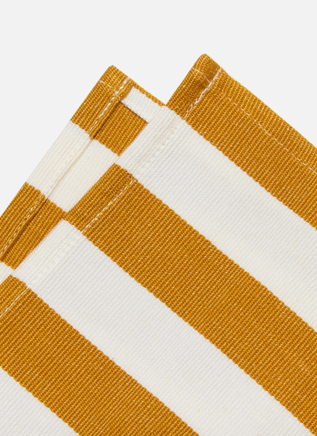 Two goldenrod and cream stripe napkins showing the heavyweight cotton weave up close