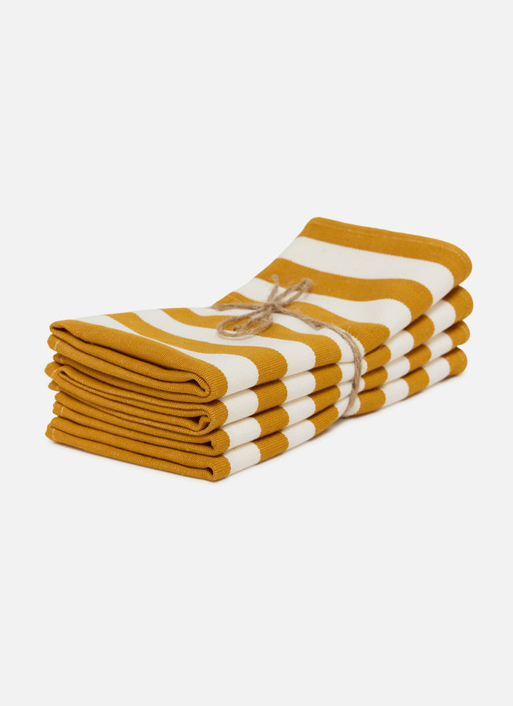 Stack of four goldenrod and cream stripe cloth napkins on a white background