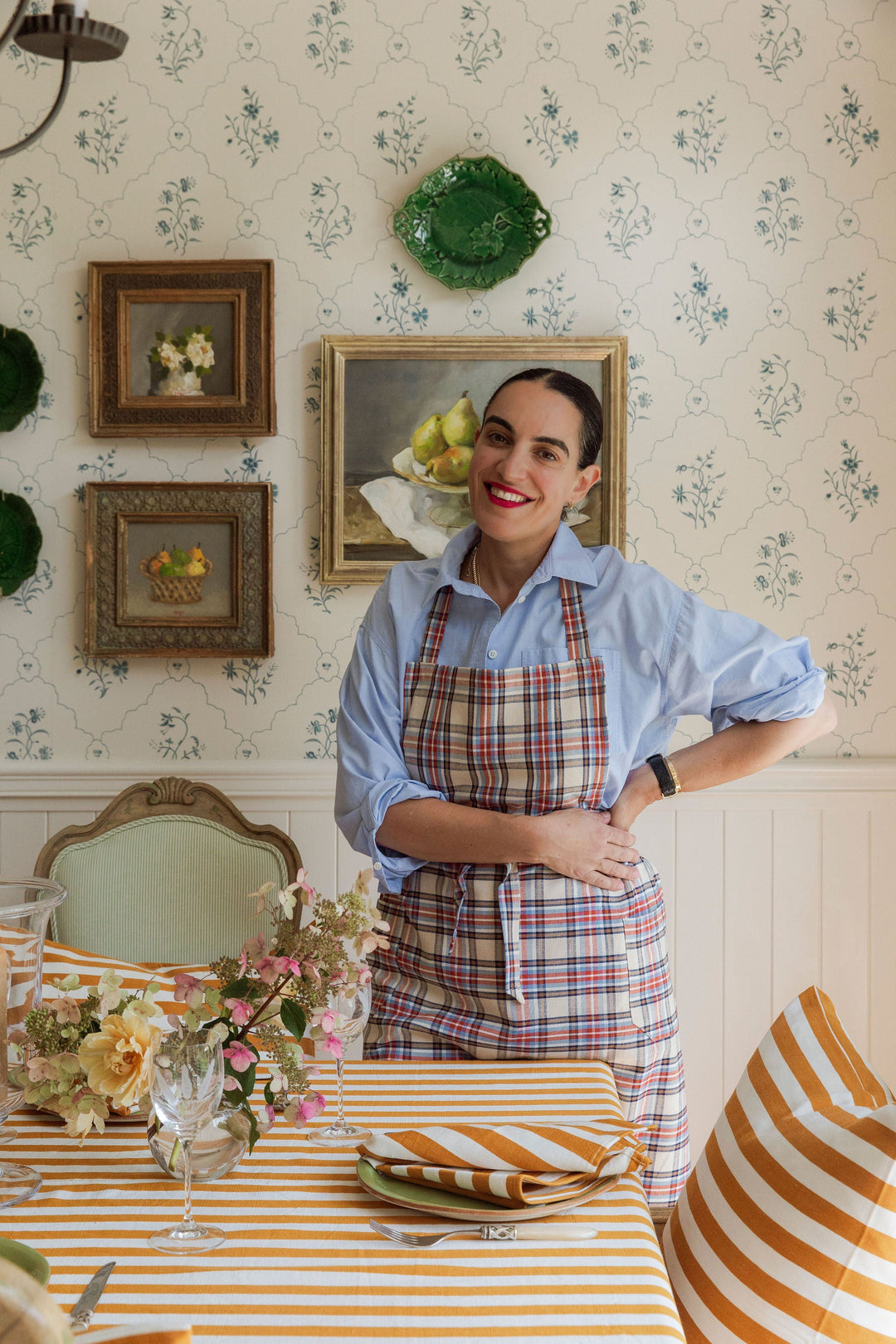 Goldenrod stripe linens styled in a papered kitchen with cut flowers and green plates