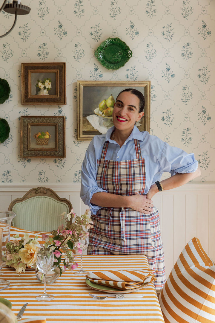 Goldenrod stripe linens styled in a papered kitchen with cut flowers and green plates