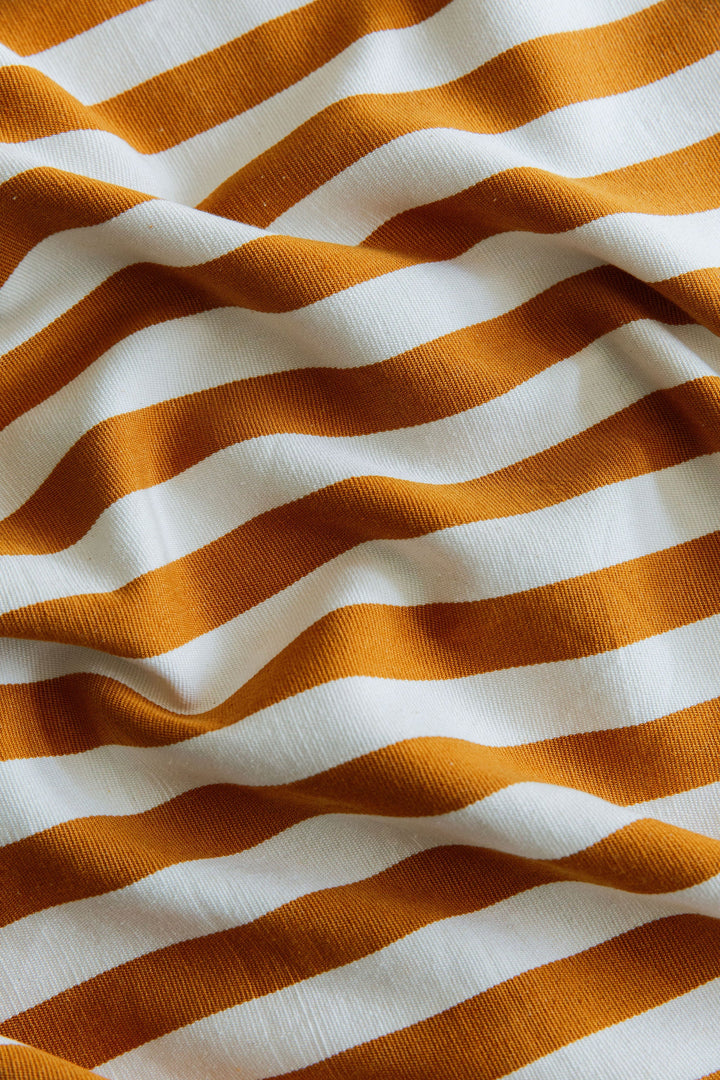 Close-up of the heavyweight handwoven cotton in the goldenrod and cream stripe