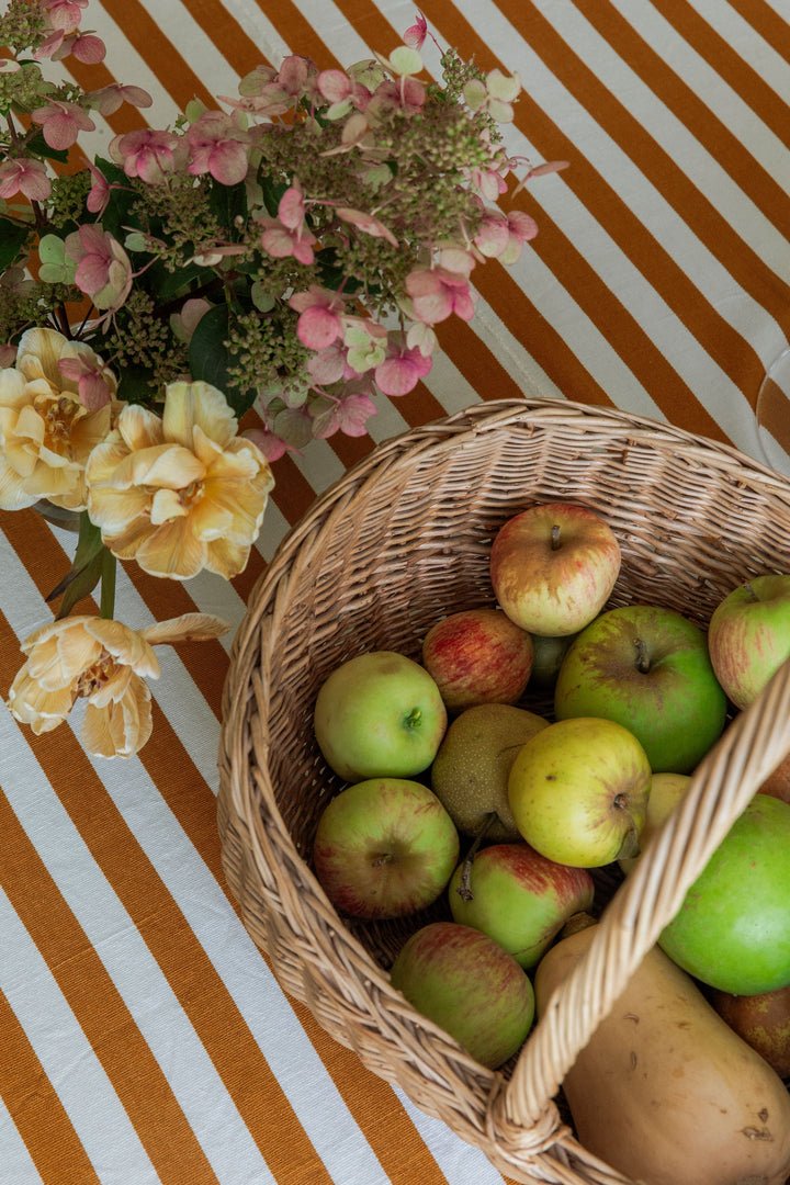 Basket of green apples and pears on the goldenrod and cream stripe tablecloth