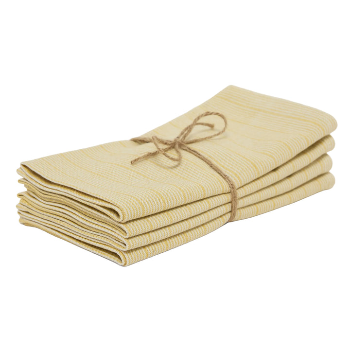 Stack of folded beige napkins tied with twine on a white background