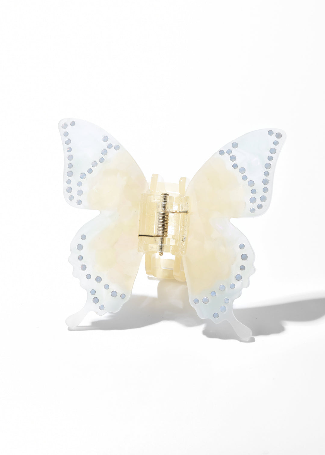 Yellow iridescent acrylic butterfly claw clip with dotted wing edges on a white background