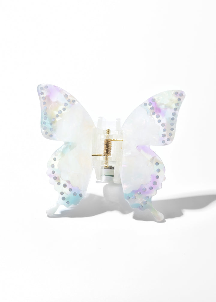 White iridescent acrylic butterfly claw clip with dotted wing edges on a white background