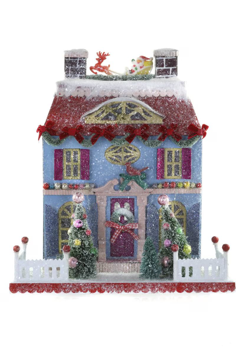 Blue glitter paper Christmas house with Santa's sleigh and reindeer on the roof for holiday village decor