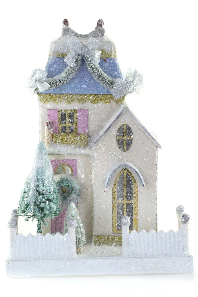 Frosted white glitter paper Christmas cottage with a blue roof, pink shutters, and a snowy tree for a holiday village