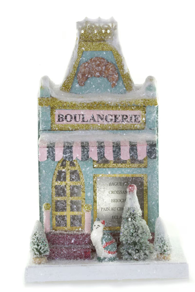 Blue glitter paper Boulangerie French bakery Christmas house with a striped awning and bottle brush trees for holiday decor