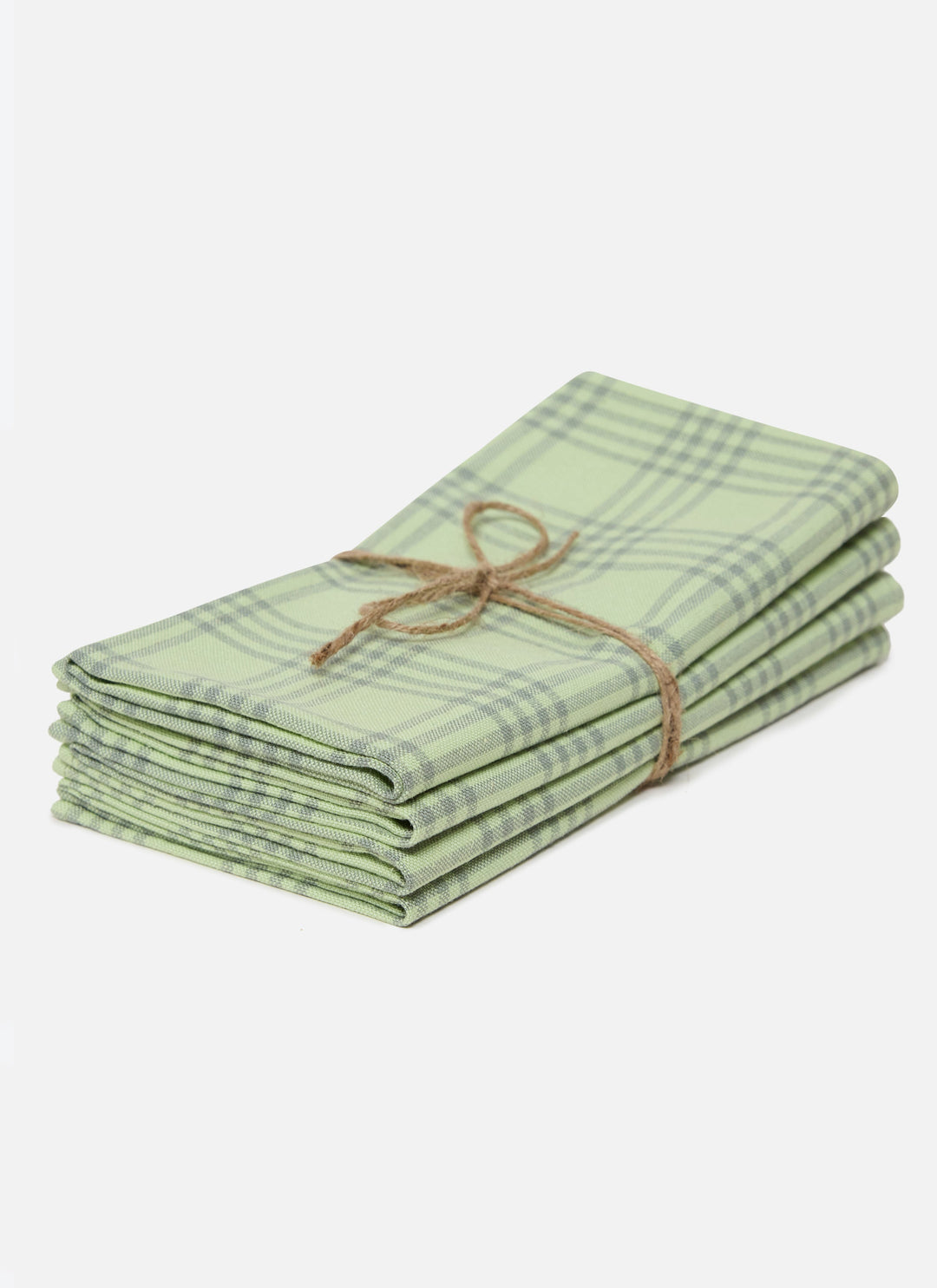 Stack of four Montauk sprout green napkins tied with twine on a white background